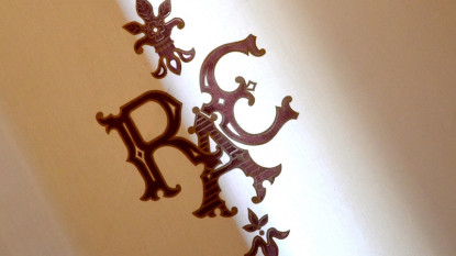 Las siglas de la RAE sobre una cortina.